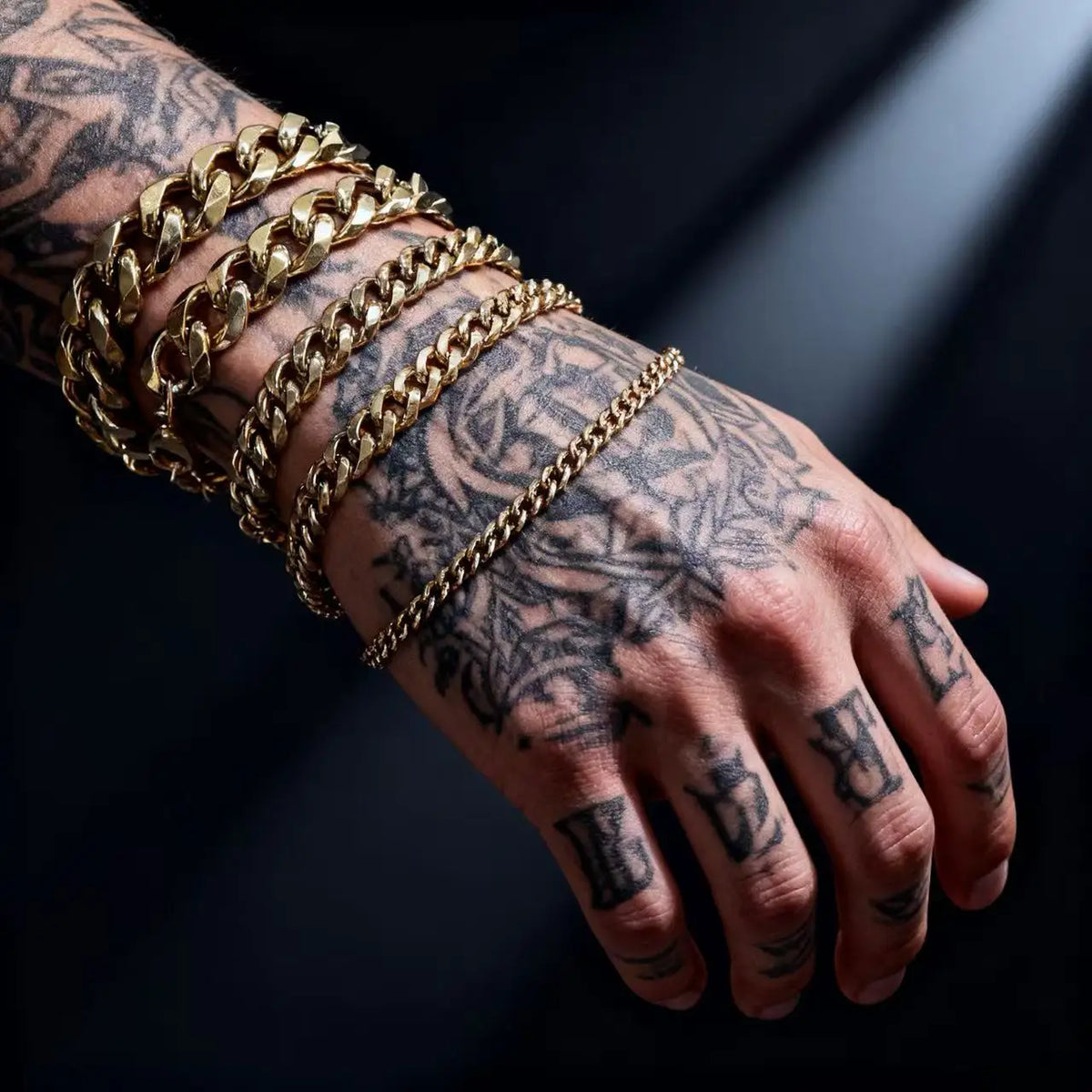 The District Cuban Bracelet in gold, worn on wrist