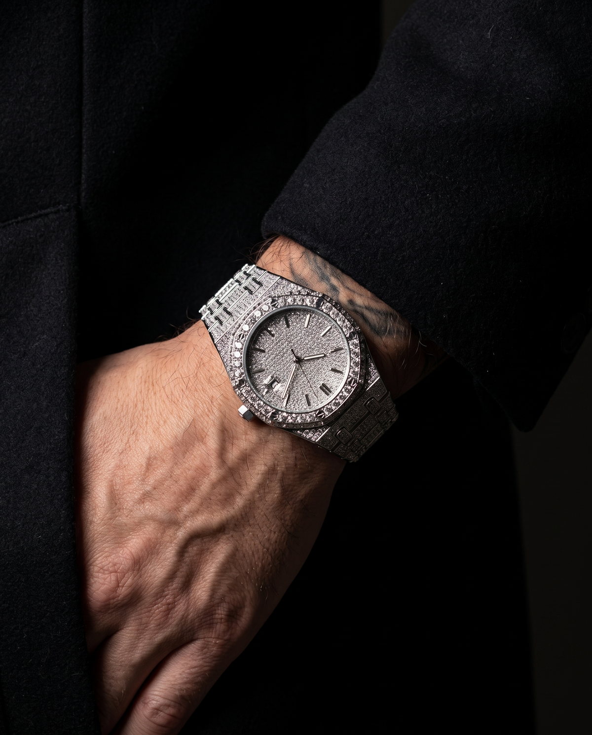 The Afterglow Watch in Silver, on-model wrist campaign image, dark editorial styling