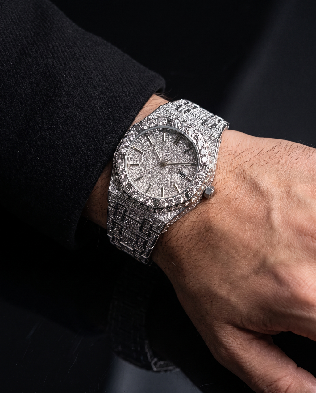 The Afterglow Watch in Silver, on-model wrist campaign image, resting on dark surface