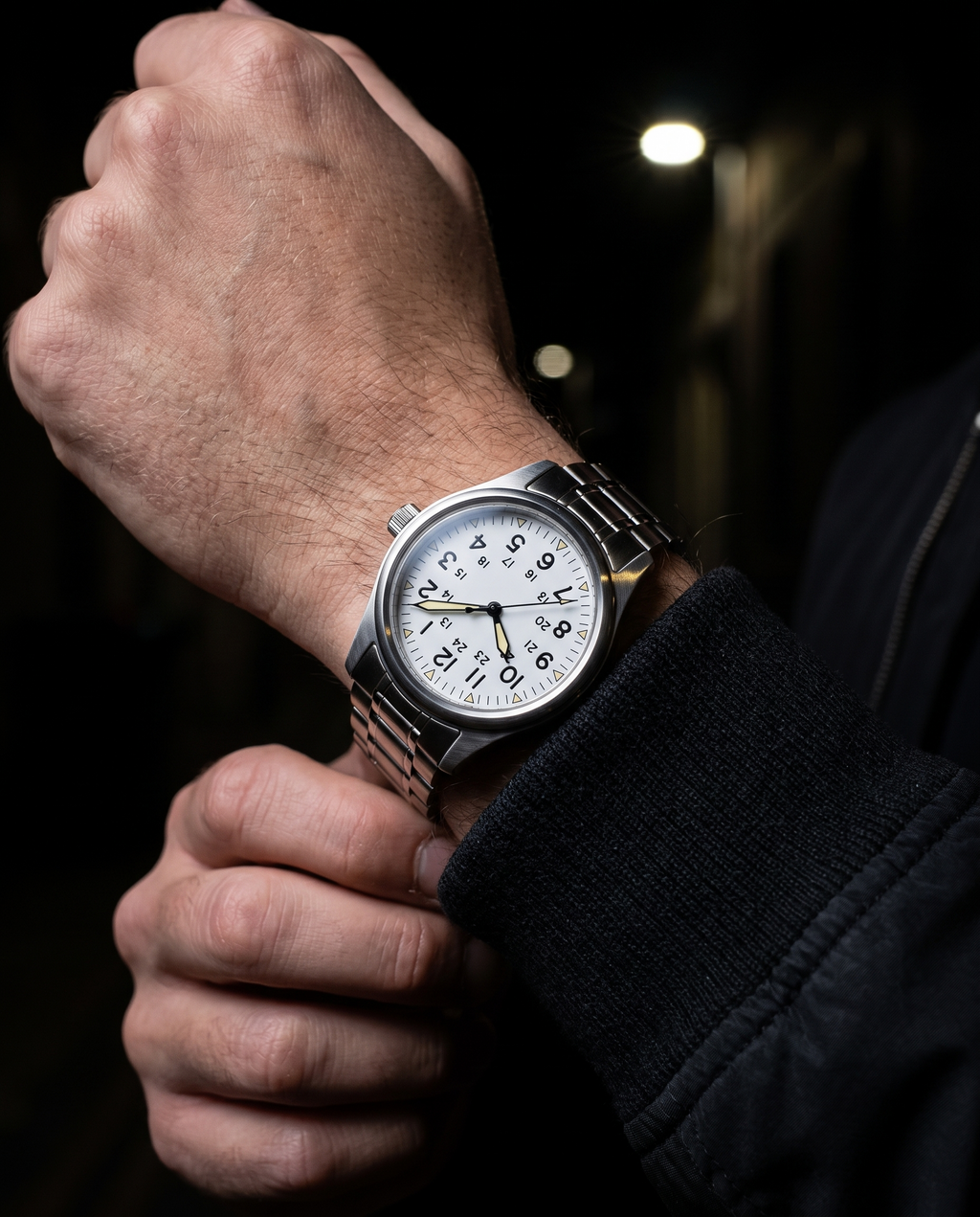 The Sentinel Watch in White, on-model wrist campaign image, dark alley styling