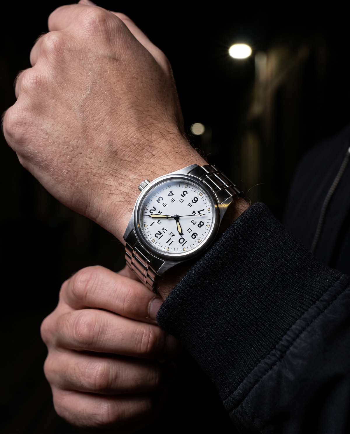 The Sentinel Watch in White, on-model wrist campaign image, dark alley styling