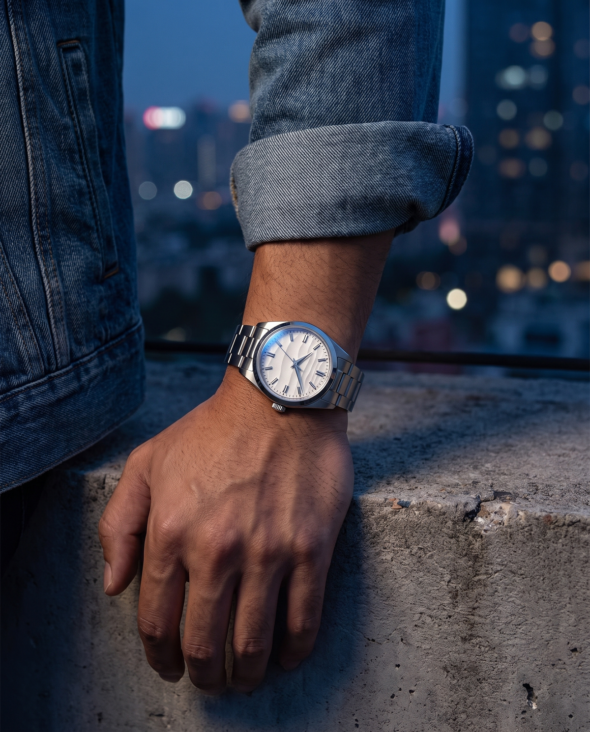 The Meridian Watch worn on wrist, denim jacket, night skyline