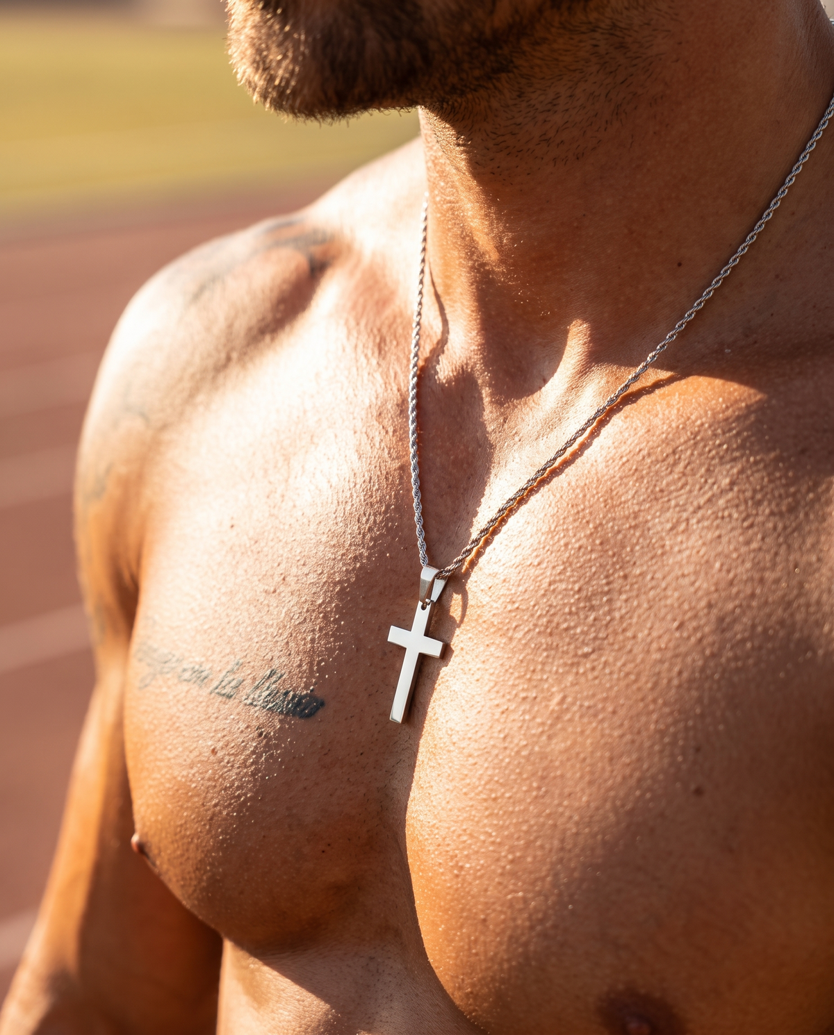 Rope Cross Necklace worn on bare chest, sunlit, dark editorial