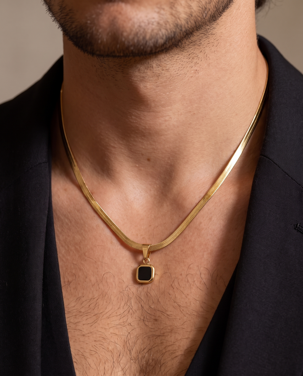 Geometric Stone Pendant worn on chest, gold herringbone chain, dark editorial