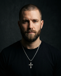 The Solace Cross Necklace worn on model, dark editorial styling